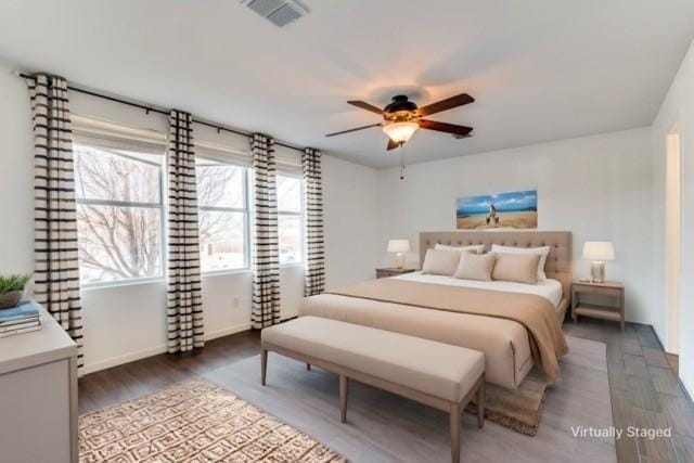 bedroom with dark wood-type flooring and ceiling fan