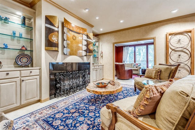 living room featuring crown molding, built in features, and a fireplace