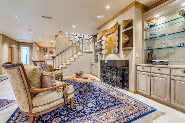 living room with crown molding and a fireplace