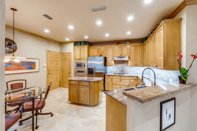 kitchen featuring sink, appliances with stainless steel finishes, kitchen peninsula, a kitchen island, and light stone countertops