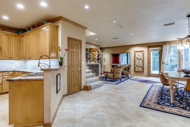 kitchen with sink, ornamental molding, decorative backsplash, kitchen peninsula, and light brown cabinets