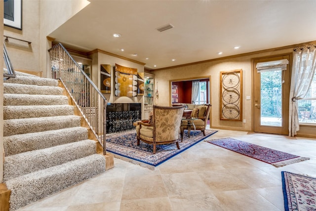 living room featuring ornamental molding and a healthy amount of sunlight