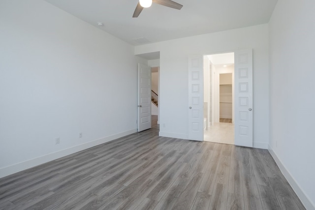 unfurnished bedroom featuring ceiling fan and light wood-type flooring