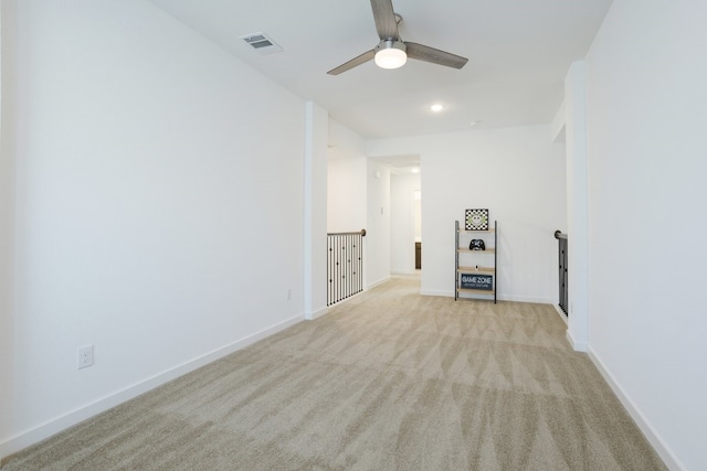 carpeted empty room featuring ceiling fan