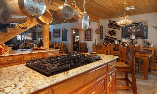 kitchen featuring light stone counters, wooden ceiling, a notable chandelier, pendant lighting, and black gas cooktop