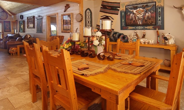 dining area with lofted ceiling and wood ceiling