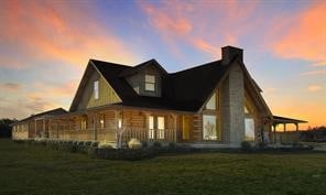 exterior space featuring a porch and a yard