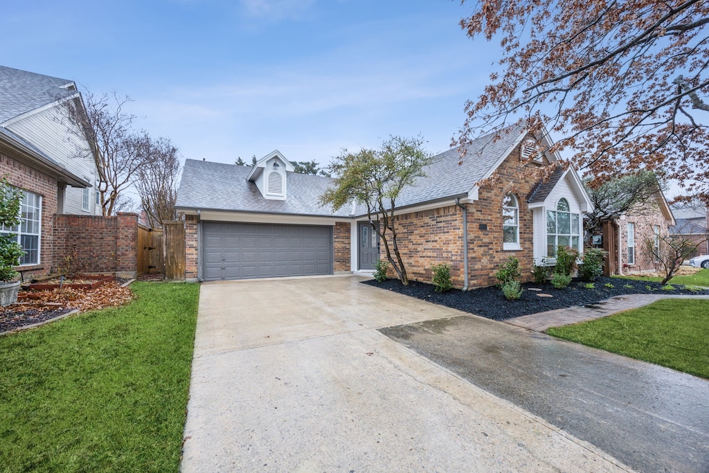 view of front facade with a garage and a front lawn