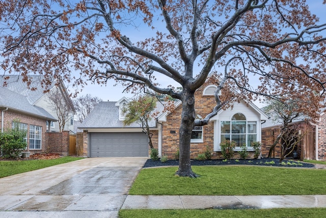 view of front of property with a garage and a front lawn