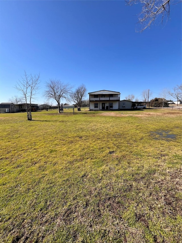 view of yard with a rural view