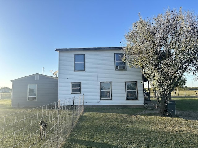 rear view of property featuring a yard