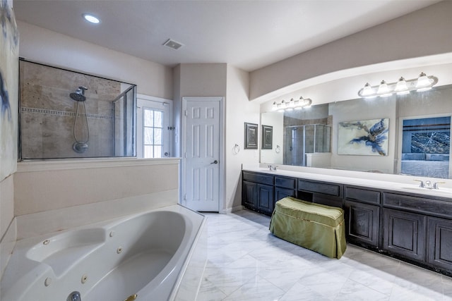 bathroom featuring vanity and shower with separate bathtub