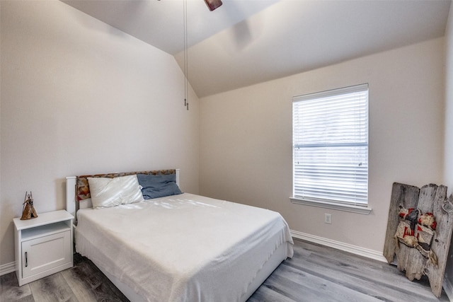 bedroom featuring vaulted ceiling, ceiling fan, and light wood-type flooring