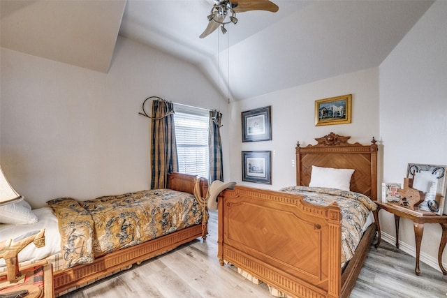 bedroom featuring lofted ceiling, ceiling fan, and light hardwood / wood-style flooring