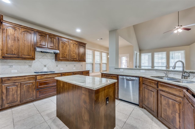 kitchen with dishwasher, a kitchen island, sink, and light tile patterned floors