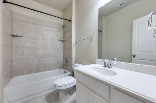 full bathroom featuring tiled shower / bath, vanity, tile patterned floors, and toilet