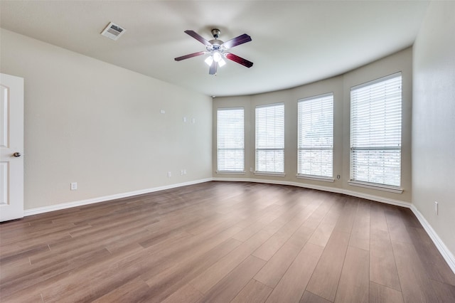 empty room featuring ceiling fan and light wood-type flooring