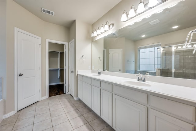 bathroom featuring vanity, tile patterned flooring, and a shower with door