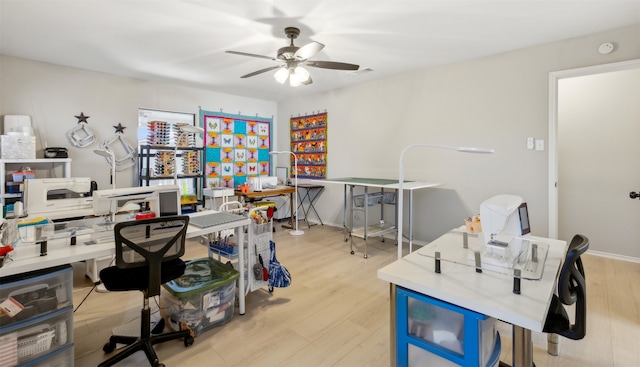 office with light hardwood / wood-style floors and ceiling fan