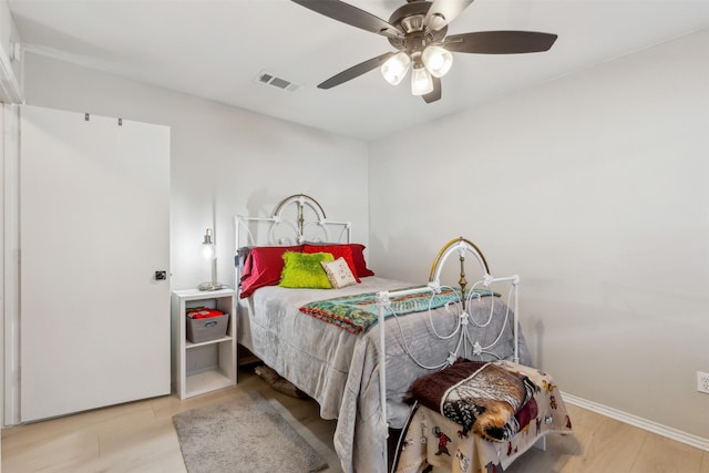 bedroom with light hardwood / wood-style flooring and ceiling fan