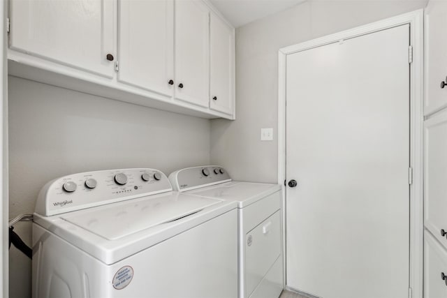 laundry area featuring cabinets and separate washer and dryer