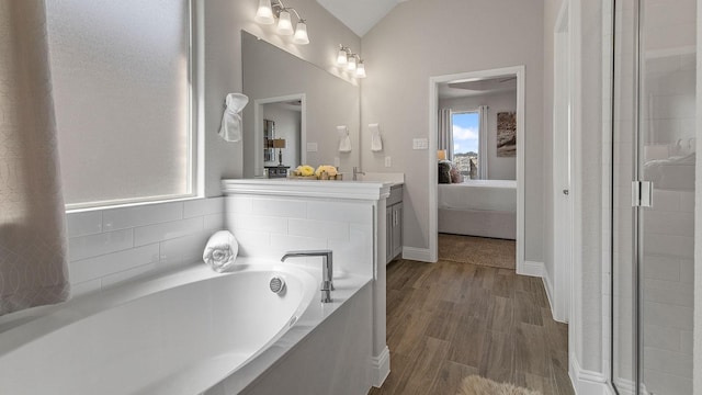 bathroom with lofted ceiling, independent shower and bath, and wood-type flooring