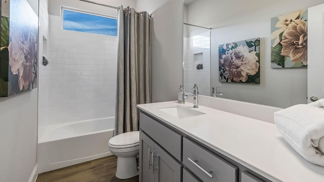 full bathroom featuring wood-type flooring, toilet, shower / tub combo with curtain, and vanity