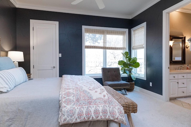 bedroom featuring ensuite bathroom, sink, light colored carpet, ornamental molding, and ceiling fan