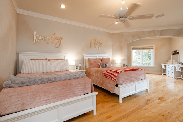 bedroom with ornamental molding, ceiling fan, and light wood-type flooring