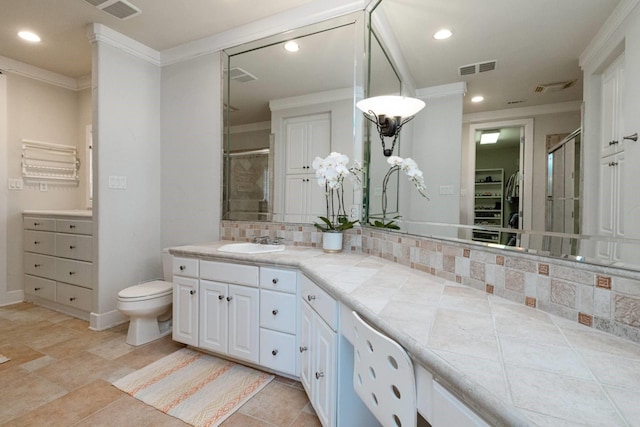 bathroom with crown molding, vanity, an enclosed shower, decorative backsplash, and toilet