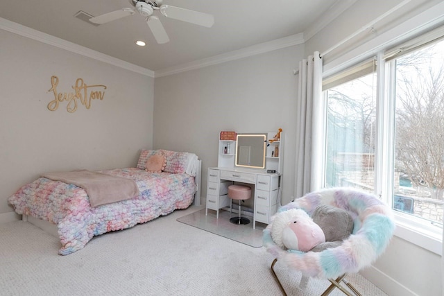 carpeted bedroom with ornamental molding and ceiling fan