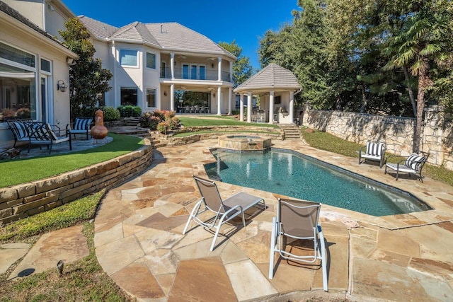 view of pool with an in ground hot tub and a patio