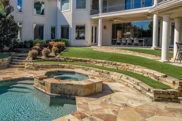 view of pool featuring an in ground hot tub, ceiling fan, and a patio area