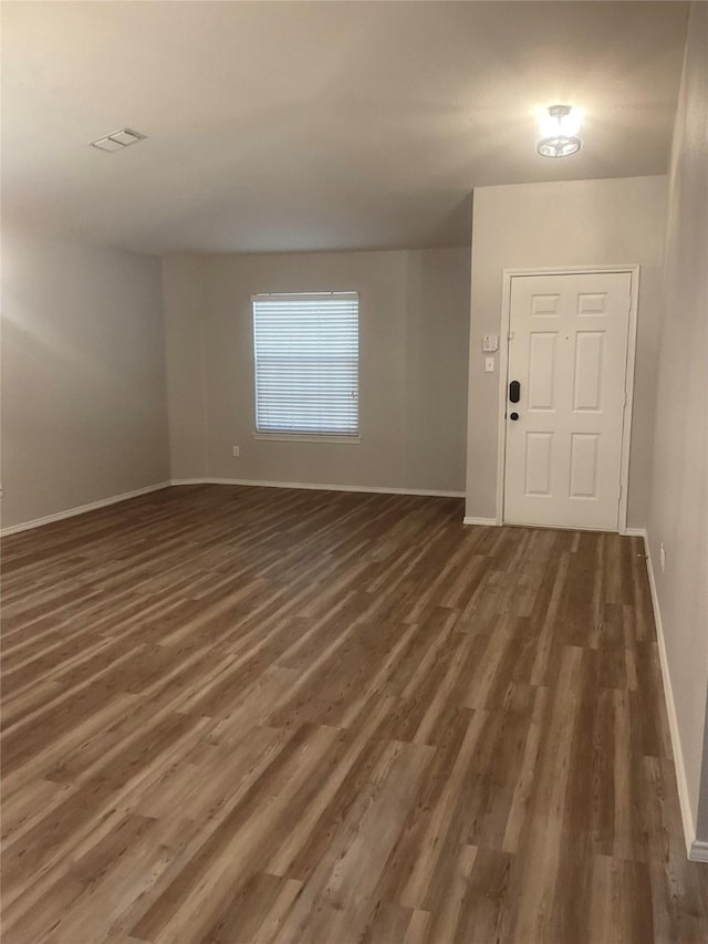 foyer entrance with dark hardwood / wood-style floors