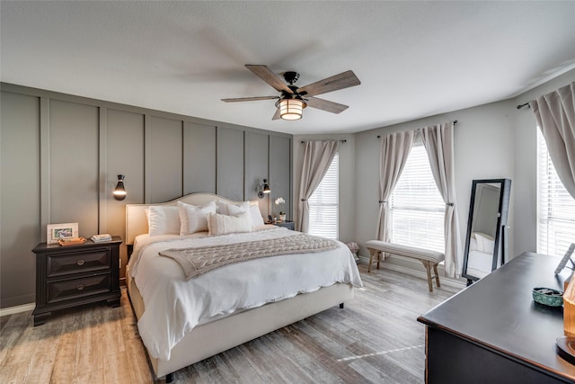 bedroom with ceiling fan and light wood-type flooring