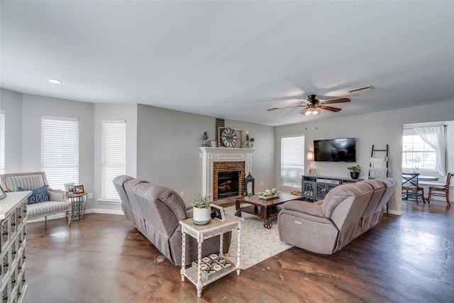 living room with a brick fireplace and ceiling fan