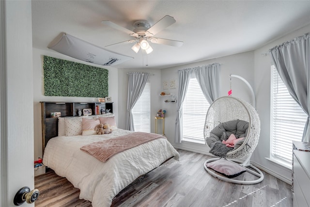 bedroom featuring hardwood / wood-style flooring and ceiling fan