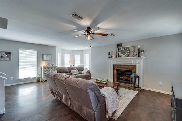 living room with ceiling fan, a brick fireplace, and a textured ceiling