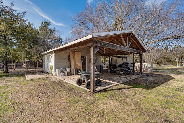 exterior space with a carport and fence