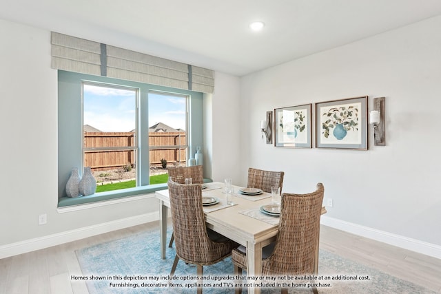 dining space with hardwood / wood-style floors