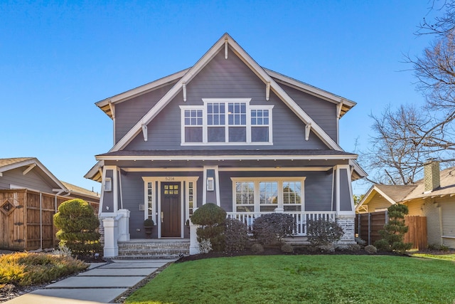 view of front of home with covered porch and a front yard