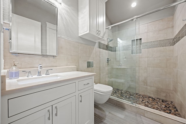 bathroom featuring toilet, an enclosed shower, tile walls, vanity, and backsplash