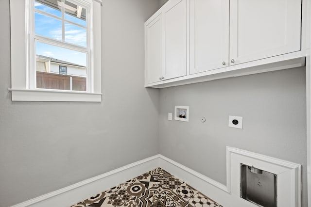 clothes washing area featuring cabinets, hookup for an electric dryer, hookup for a gas dryer, and hookup for a washing machine