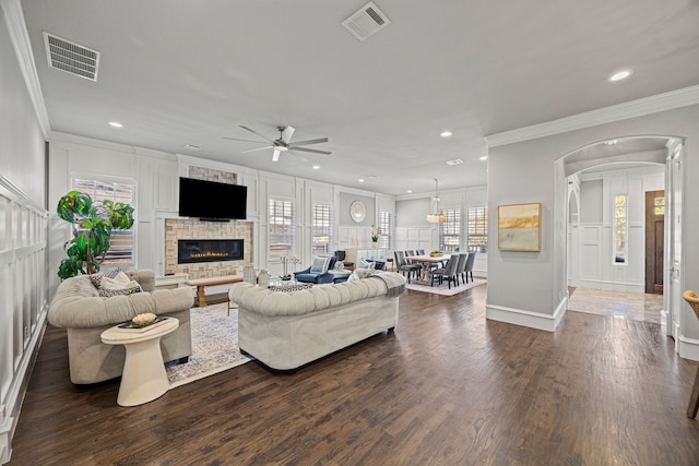 living room with ornamental molding, ceiling fan, and dark hardwood / wood-style flooring