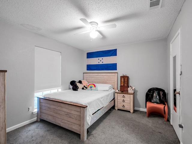 bedroom with ceiling fan, carpet, and a textured ceiling