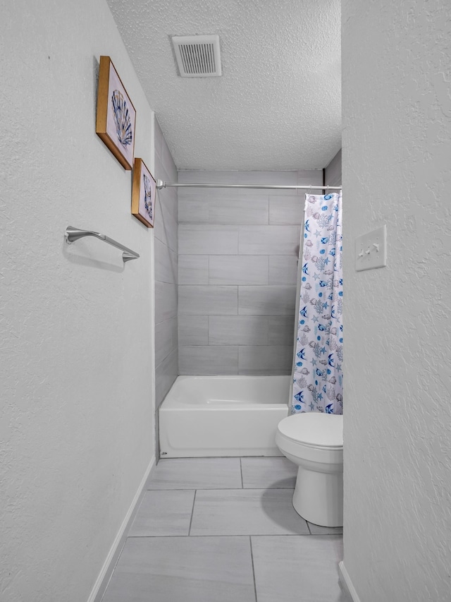 bathroom featuring shower / bathtub combination with curtain, toilet, and a textured ceiling