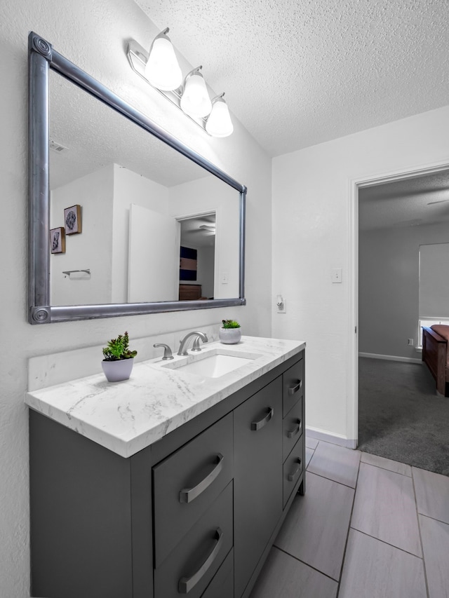 bathroom featuring vanity and a textured ceiling