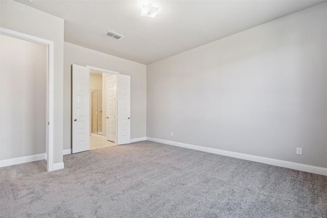 unfurnished bedroom featuring light carpet