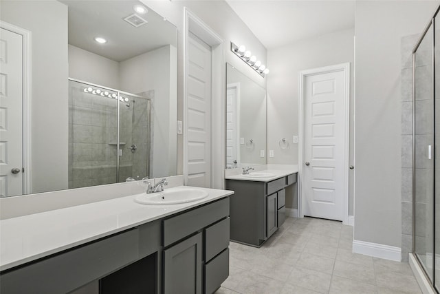 bathroom featuring vanity, tile patterned flooring, and a shower with door