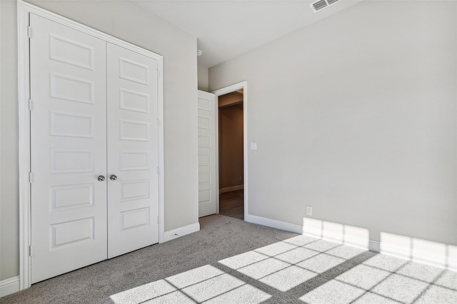 unfurnished bedroom with a closet and light carpet